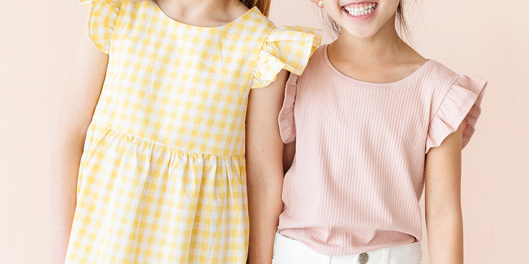 Two young girls wearing easter colored clothing